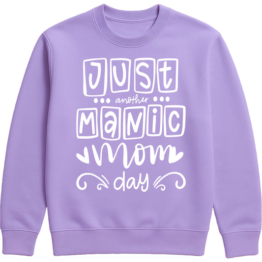 Lavender sweatshirt with 'Just Another Manic Mom Day' printed on the front, styled for casual everyday wear, perfect for moms balancing busy lives.
