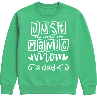 A kelly green colour sweatshirt with 'Just Another Manic Mom Day' printed on the front, styled for casual everyday wear, perfect for moms balancing busy lives.