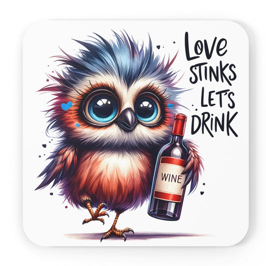 Funny Coaster set featuring a colourful, wide-eyed cartoon owl with blue and orange feathers holds a bottle of wine. The coaster features the playful phrase 'Love stinks, let's drink' in bold, black lettering. The background is white, with small heart accents around the owl.
