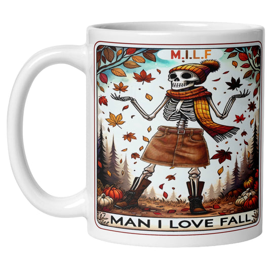 White coffee mug featuring a stylish skeleton surrounded by colourful autumn leaves and the phrase "M.I.L.F. Man I Love Fall", perfect for pumpkin spice season, cosy autumn mornings, and fall lovers.