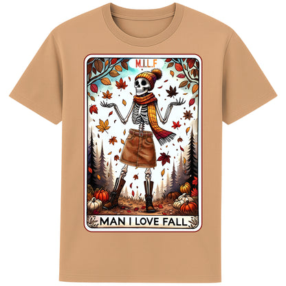 A latte colour graphic t-shirt featuring a stylish skeleton in fall attire with the phrase “M.I.L.F. – Man I Love Fall,” surrounded by autumn leaves and pumpkins.