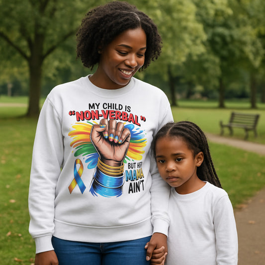 Mother wearing a My Child Is Non Verbal But Her Mama Ain't autism awareness sweatshirt featuring a raised fist and autism ribbon design while holding hands with her daughter in a park setting.