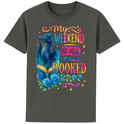 My Weekend Is All Booked book lover t-shirt featuring a blue fantasy dragon reading an enchanted book surrounded by roses and colourful bookish artwork on a anthracite colour t-shirt 