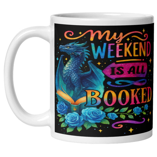 My Weekend Is All Booked coffee mug featuring a blue fantasy dragon, enchanted open book, colourful roses, and magical book lover artwork for readers and fantasy fans.