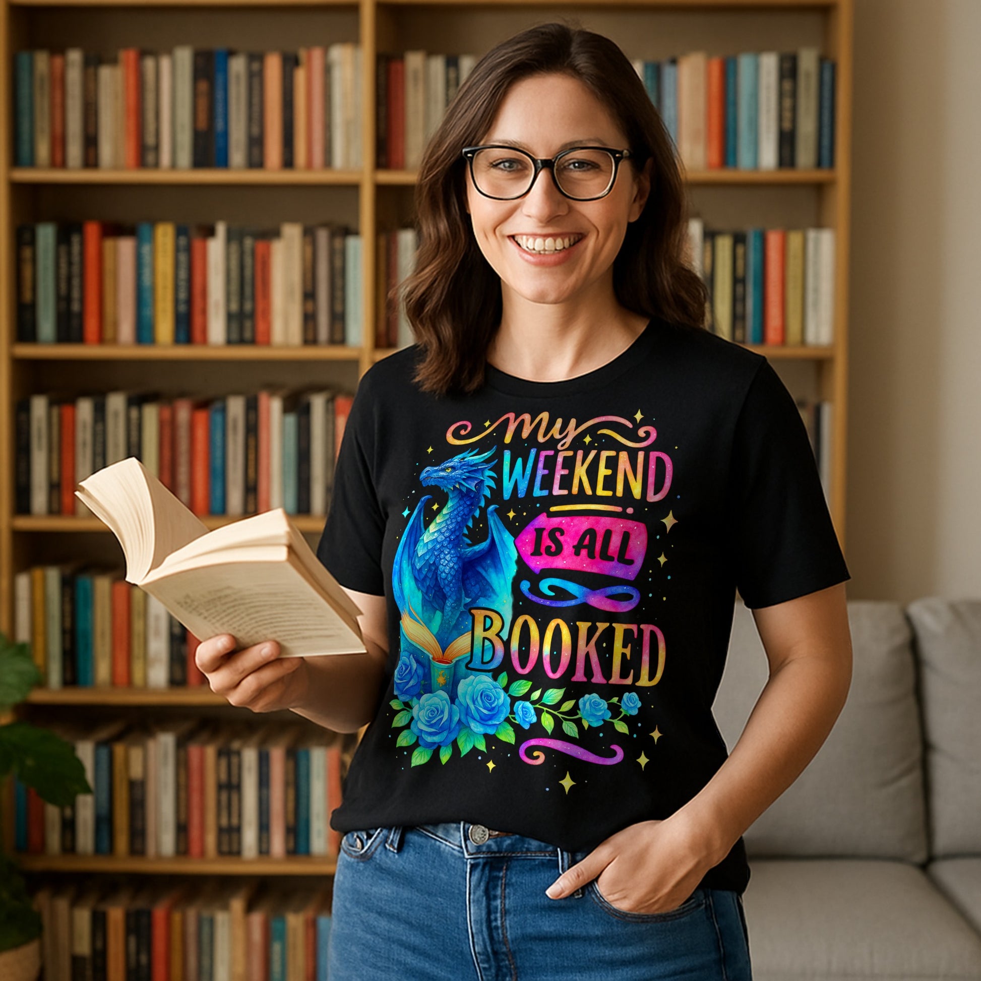 A woman wearing a black “My Weekend Is All Booked” t-shirt with blue dragon and book design