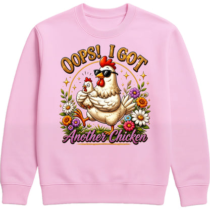 Pink Oops! I Got Another Chicken Sweatshirt featuring a funny hen wearing sunglasses with a chick, colourful wildflowers and playful farmhouse artwork for chicken lovers.