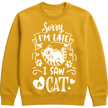 A gold colour sweatshirt featuring a lounging white cat, paw prints, and the slogan "Sorry I'm Late, I Saw a Cat", perfect for cat lovers, cat owners, and anyone who always stops to say hello to a cat.