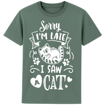 A playful green bay colour T-Shirt with white text and a charming design on the front. It reads: "Sorry I'm late I saw a cat" accompanied by a cartoon cat illustration, paw prints, and whimsical accents. Perfect for cat lovers and those who embrace their feline-induced tardiness with humor.
