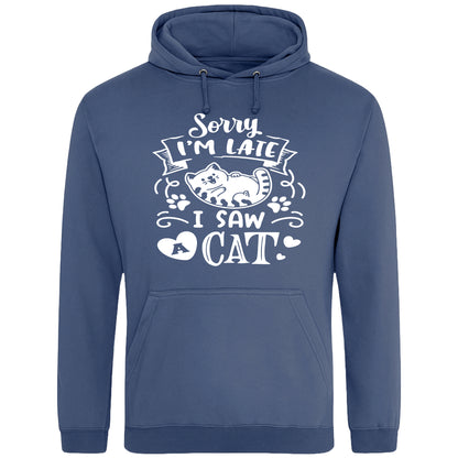 A playful airforce blue hoodie with white text and a charming design on the front. It reads: "Sorry I'm late I saw a cat" accompanied by a cartoon cat illustration, paw prints, and whimsical accents. Perfect for cat lovers and those who embrace their feline-induced tardiness with humor.