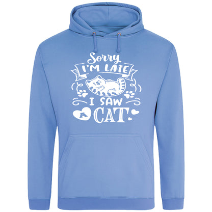 A playful blue hoodie with white text and a charming design on the front. It reads: "Sorry I'm late I saw a cat" accompanied by a cartoon cat illustration, paw prints, and whimsical accents. Perfect for cat lovers and those who embrace their feline-induced tardiness with humor.