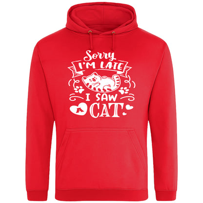 A playful red hoodie with white text and a charming design on the front. It reads: "Sorry I'm late I saw a cat" accompanied by a cartoon cat illustration, paw prints, and whimsical accents. Perfect for cat lovers and those who embrace their feline-induced tardiness with humor.