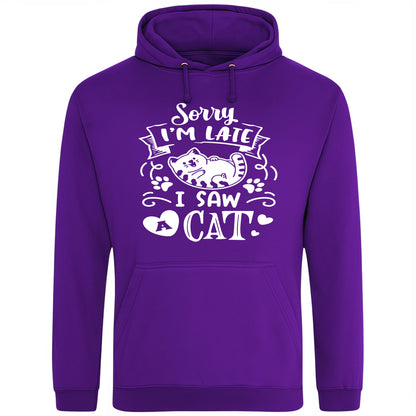 A playful purple hoodie with white text and a charming design on the front. It reads: "Sorry I'm late I saw a cat" accompanied by a cartoon cat illustration, paw prints, and whimsical accents. Perfect for cat lovers and those who embrace their feline-induced tardiness with humor.