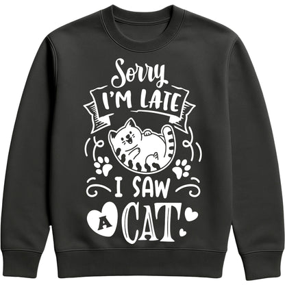 A black sweatshirt with white text and a charming design on the front. It reads: "Sorry I'm late I saw a cat" accompanied by a cartoon cat illustration, paw prints, and whimsical accents. Perfect for cat lovers and those who embrace their feline-induced tardiness with humour.
