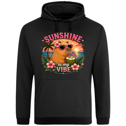 Black Sunshine Is My Vibe Capybara Hoodie featuring a tropical beach graphic with a relaxed capybara, palm trees, hibiscus flowers and a colourful summer sunset.