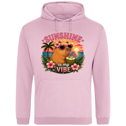 Pink Sunshine Is My Vibe Capybara Hoodie featuring a tropical beach graphic with a relaxed capybara, palm trees, hibiscus flowers and a colourful summer sunset.