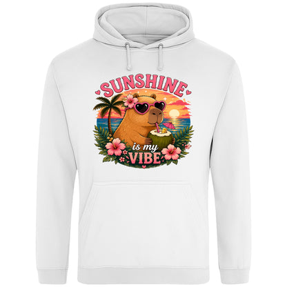 White Sunshine Is My Vibe Capybara Hoodie featuring a tropical beach graphic with a relaxed capybara, palm trees, hibiscus flowers and a colourful summer sunset.