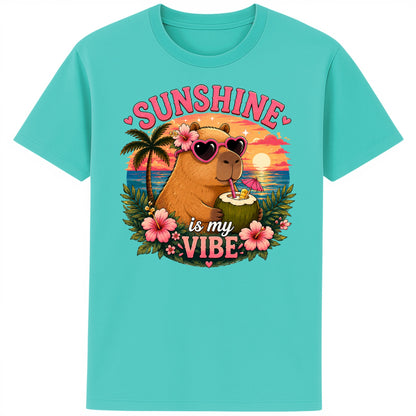 Pool blue colour Sunshine Is My Vibe Capybara T-Shirt featuring a cute capybara wearing heart-shaped sunglasses, holding a coconut drink with tropical flowers, palm trees and a colourful summer beach sunset graphic.