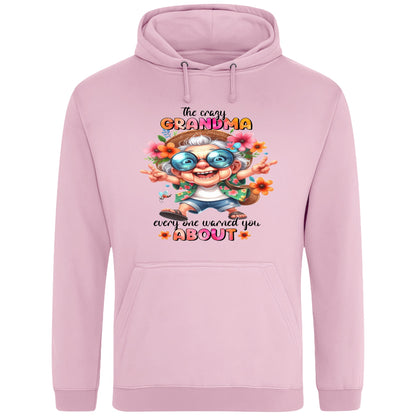 Pink funny grandma hoodie featuring a colourful cartoon grandma wearing sunglasses with the phrase "The Crazy Grandma Everyone Warned You About", perfect gift for grandma, grandmother birthday gift, Grandparents Day gift, and gift from grandkids.