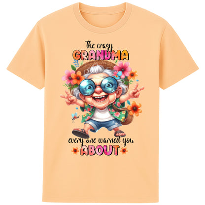 Funny grandma shirt featuring a colourful cartoon grandma wearing sunglasses and floral clothing with the quote "The Crazy Grandma Everyone Warned You About" on a fraiche peche