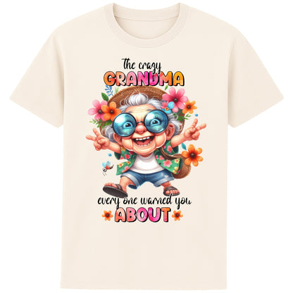 Funny grandma shirt featuring a colourful cartoon grandma wearing sunglasses and floral clothing with the quote "The Crazy Grandma Everyone Warned You About" on a naturel colour t-shirt.