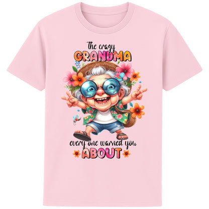 Funny grandma shirt featuring a colourful cartoon grandma wearing sunglasses and floral clothing with the quote "The Crazy Grandma Everyone Warned You About" on a pink t-shirt.