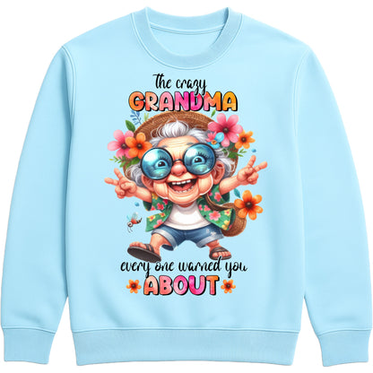 Sky blue funny grandma sweatshirt featuring a colourful cartoon grandma wearing sunglasses with the phrase "The Crazy Grandma Everyone Warned You About", perfect gift for grandma, grandmother birthday gift, Grandparents Day gift, and gift from grandkids.