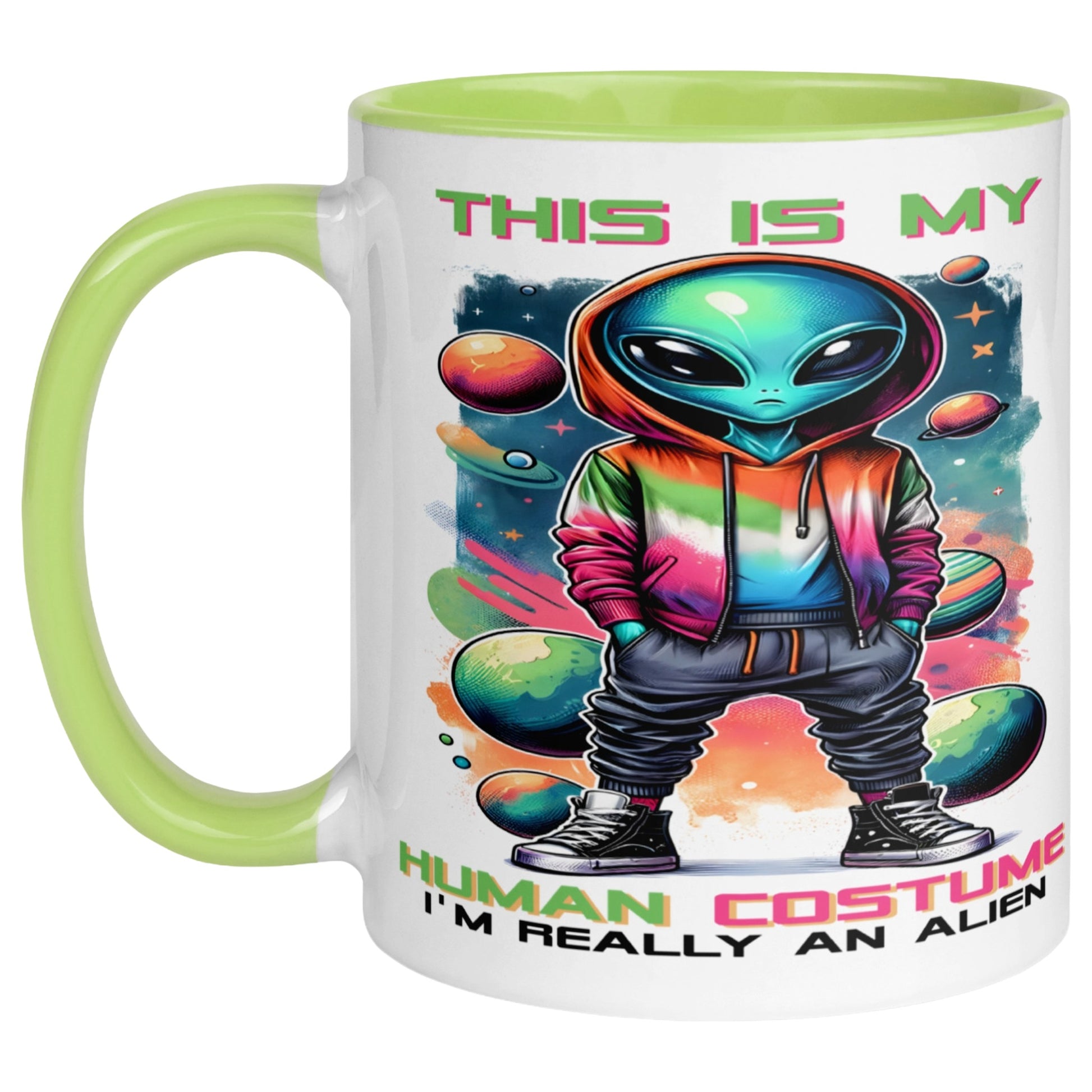 Funny UFO mug featuring a colourful alien in a rainbow hoodie surrounded by planets and cosmic artwork with the text "This Is My Human Costume I'm Really An Alien" on a white mug with a green handle and interior.